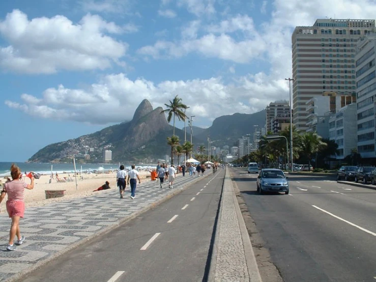 people walking on the sand near a beach