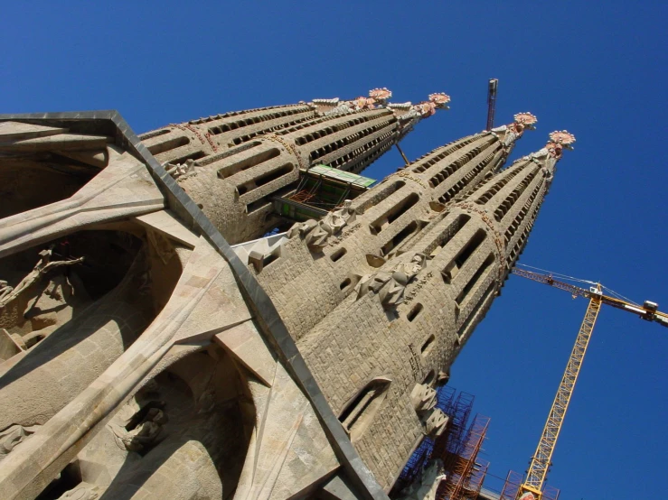 a very tall tower with a crane nearby