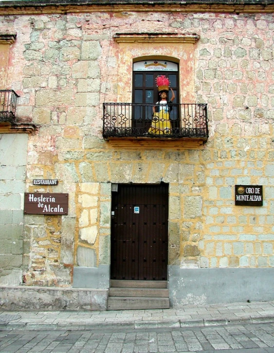 a woman in a yellow dress looking out a window