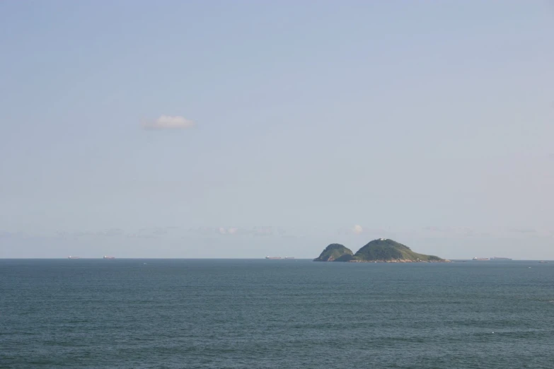 large body of water with an island in the distance