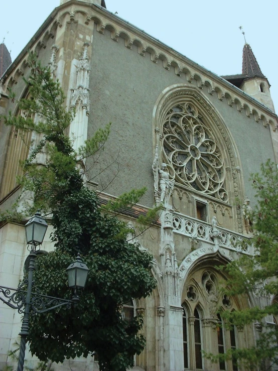 large, ornate stone building with arched windows and a massive doorway