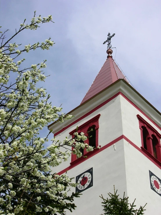 a clock on a building with red and white trim