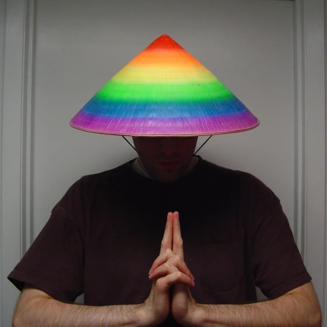 a person standing in front of a doorway with a hat on his head