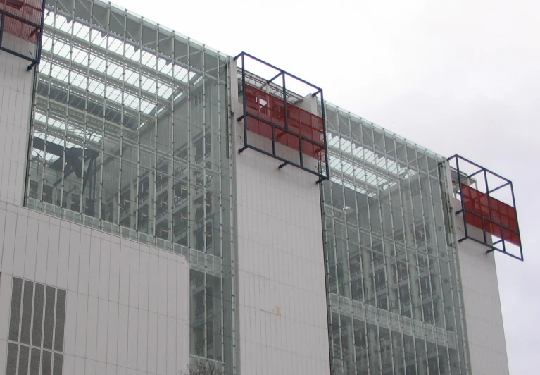 a white building with red square windows is seen