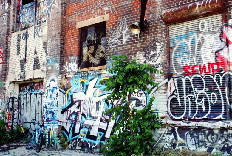 a brick building with lots of graffiti all over it