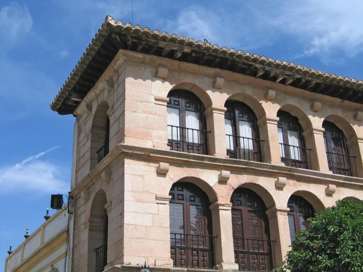 the side view of a three story building with three windows