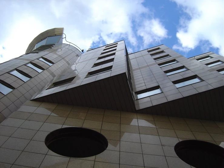 several buildings on a sunny day and the clouds are blue