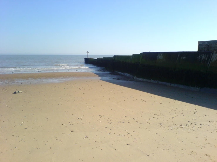 the ocean is next to some sort of pier