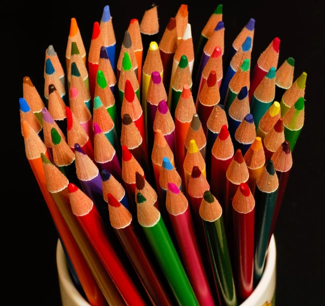 a group of pencils sitting in a mug