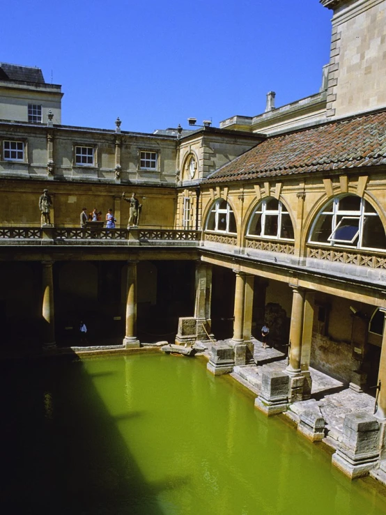 green water and people in large buildings that are sitting down