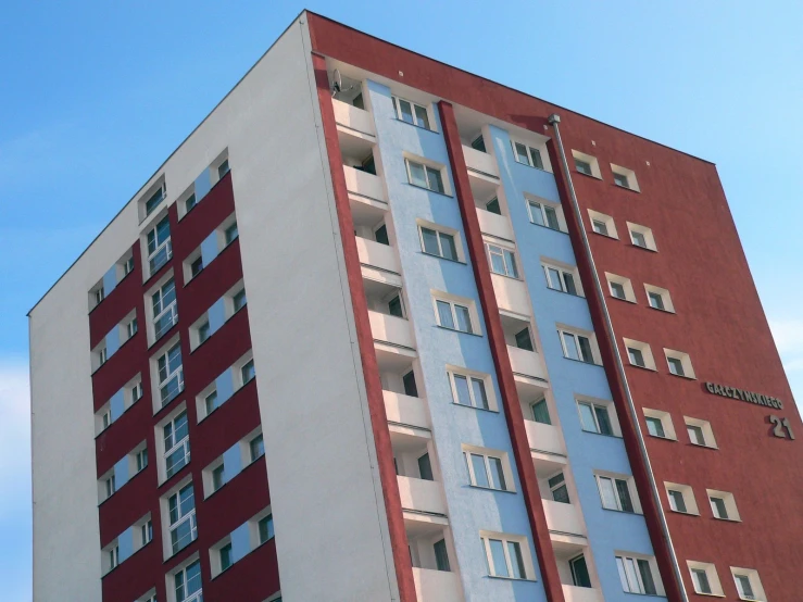 a large white and red building with multiple stories