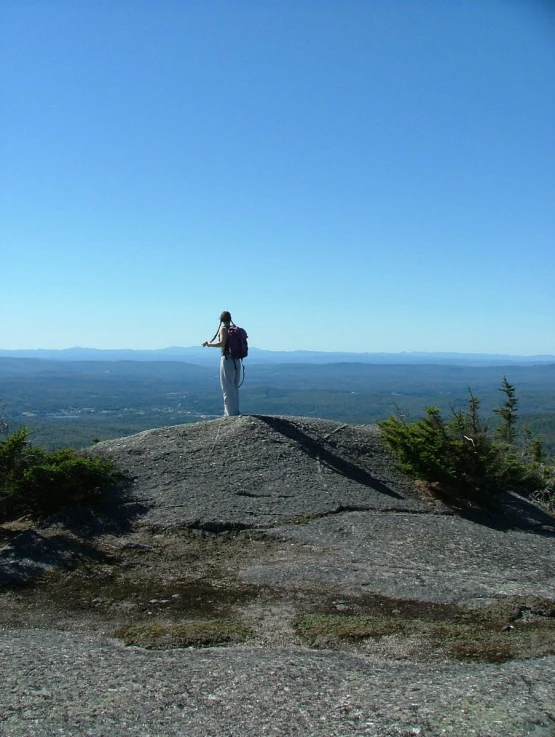 a man standing on top of a rocky cliff