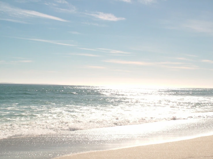 there is a person riding a surfboard at the beach