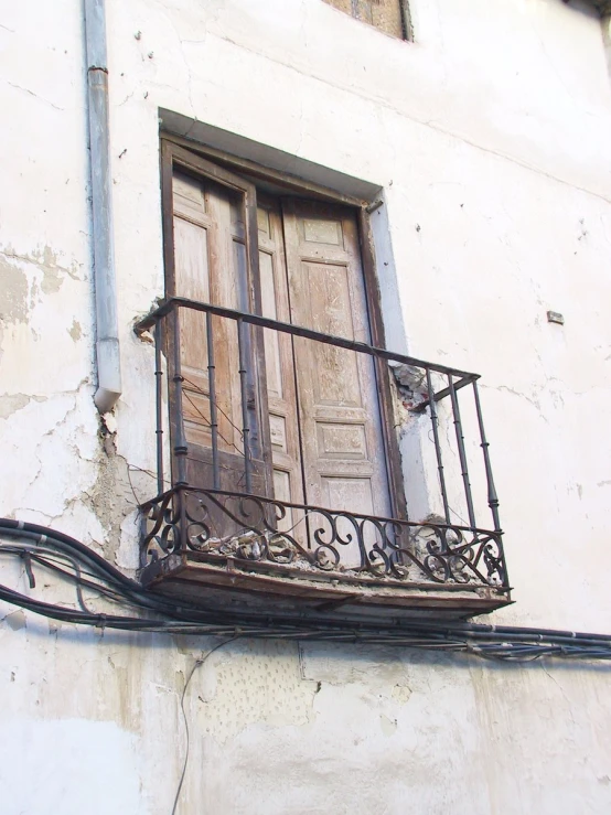 there is a balcony and door with wrought iron