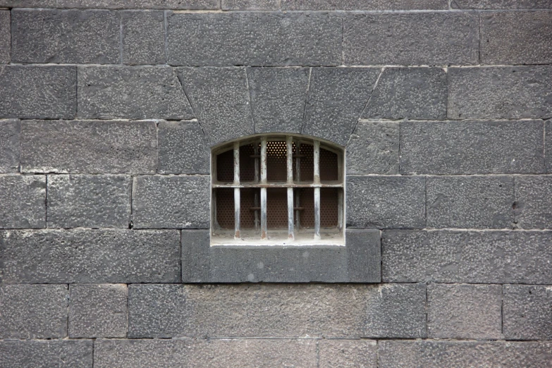 a stone wall with bars painted all over it