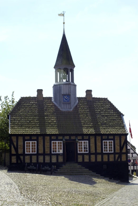 a large brown and black building with a tower