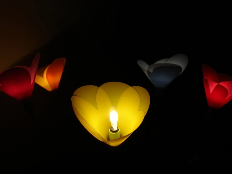a lamp in the shape of a heart and four small bowls