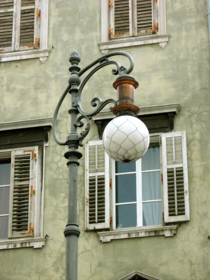 a street light in front of a multi - story building