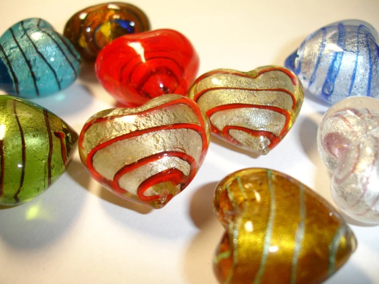 five decorative blown glass ornaments in a series of patterns