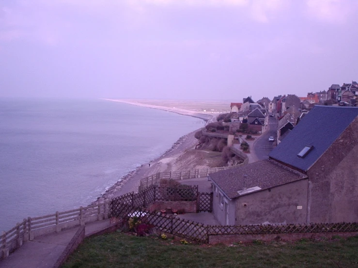 an aerial view of a small coastal village next to the ocean