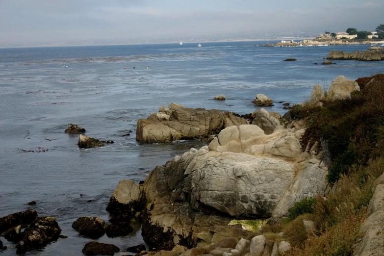 a rocky shoreline along the water with many rocks