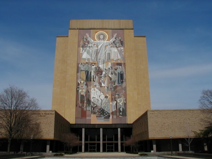 a building with a giant religious wall painting on it