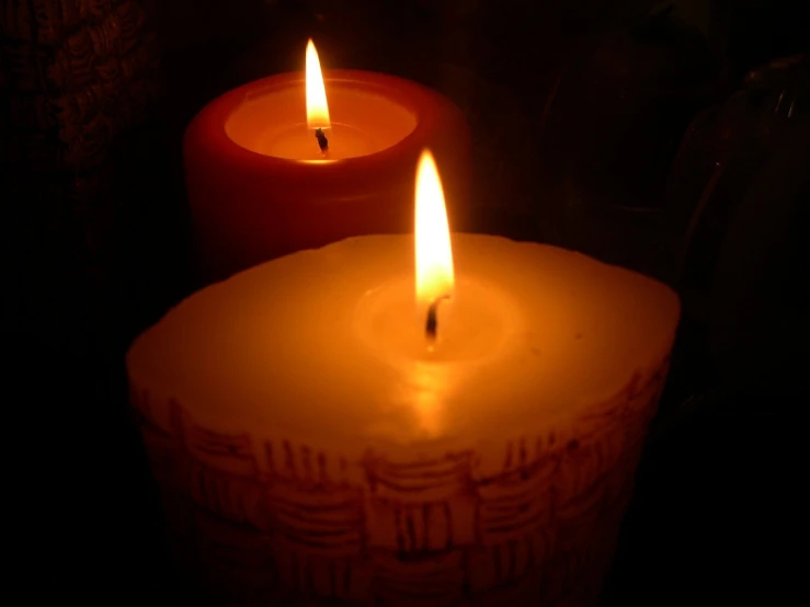 lit candles sitting on a table next to each other