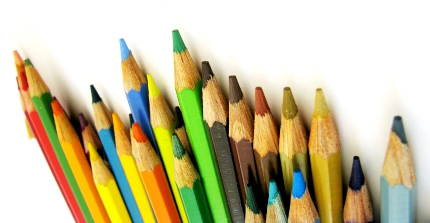 a row of pencils in a holder attached to the wall