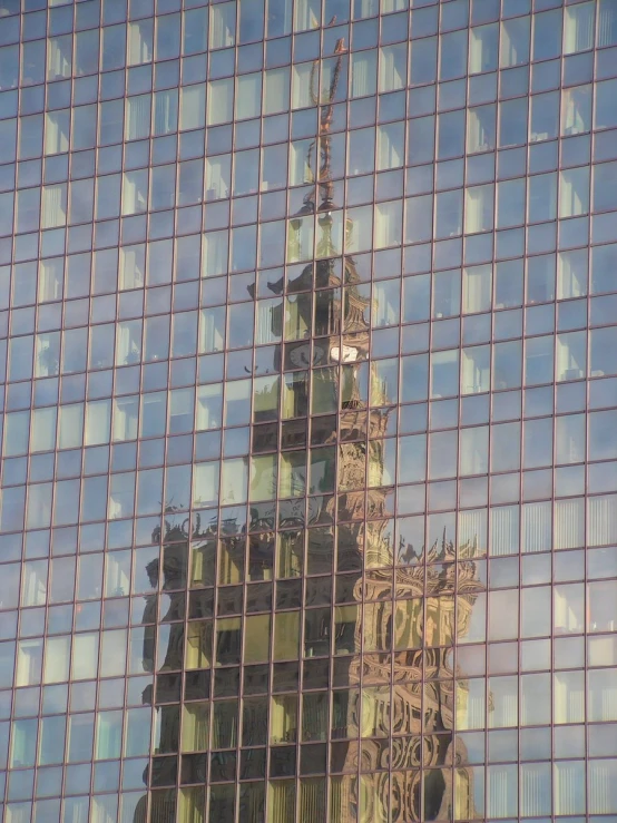 a reflection of a clock tower in a building