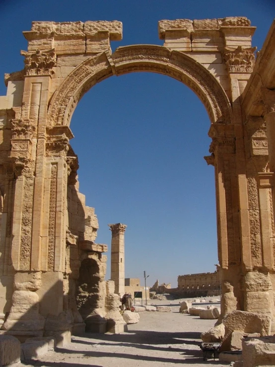 a stone arch standing in the middle of the road