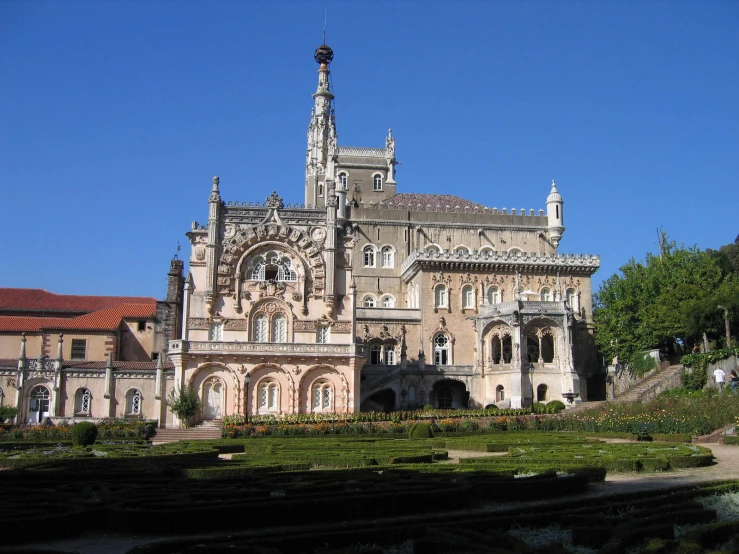 a building with a clock tower towering over a grassy field