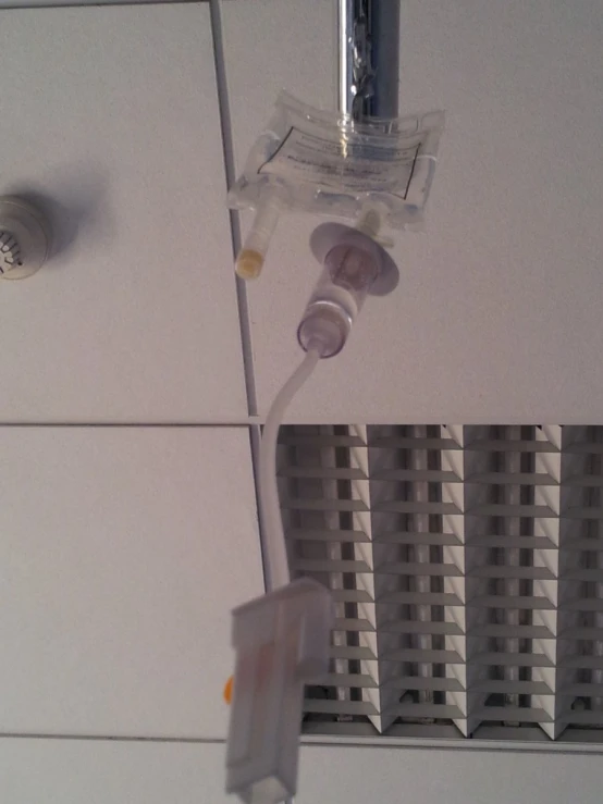 a hospital drip and driping machine is attached to the wall