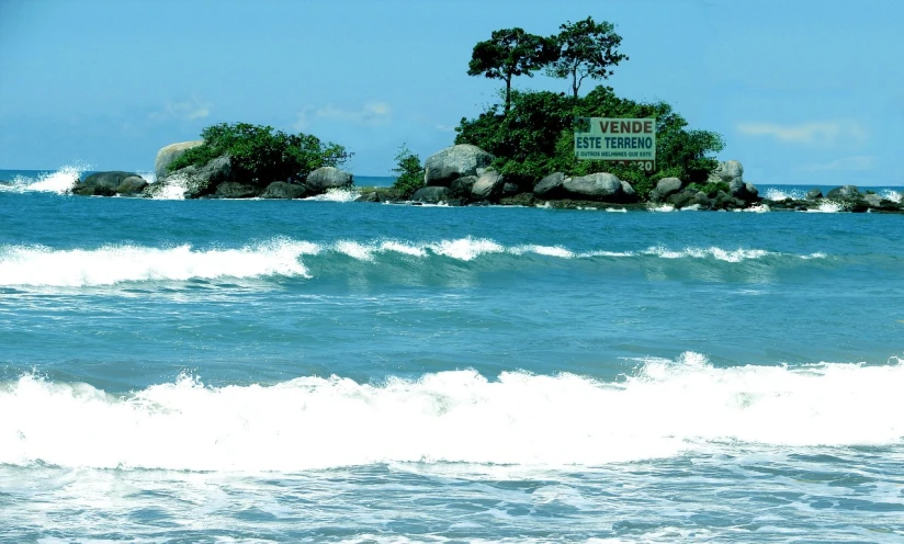 an island on a rocky beach in the water