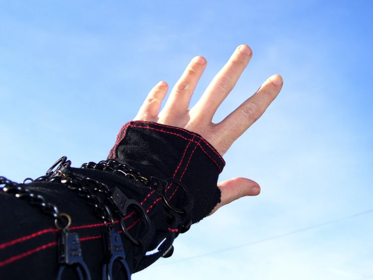 a hand holding up the sky for a kite