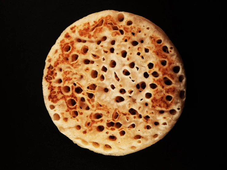 a closeup of a tortilla against a dark background