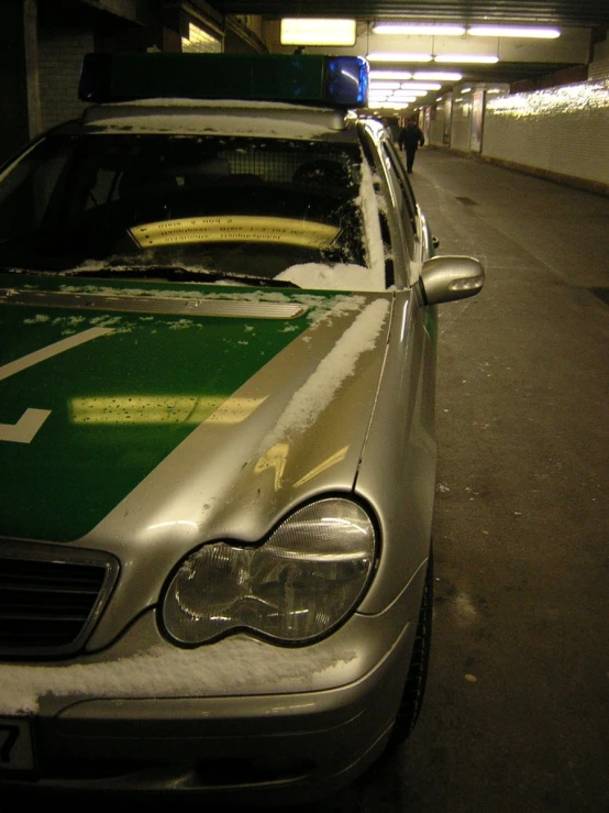 the front of a mercedes sits parked at a parking garage