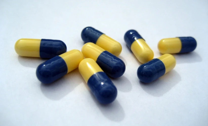 pill shaped pill pills in blue and yellow on white background