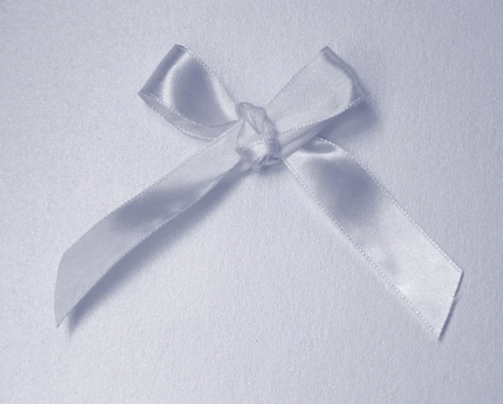 a light gray bow tied with ribbon