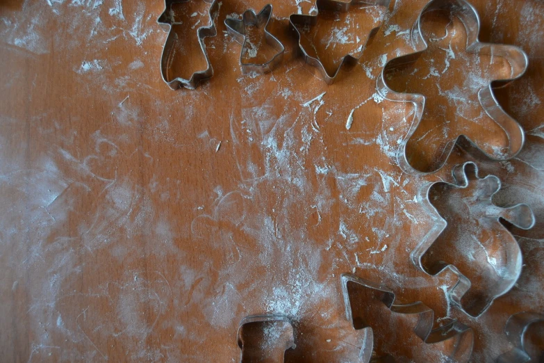 several cookie cutters are on a wooden surface