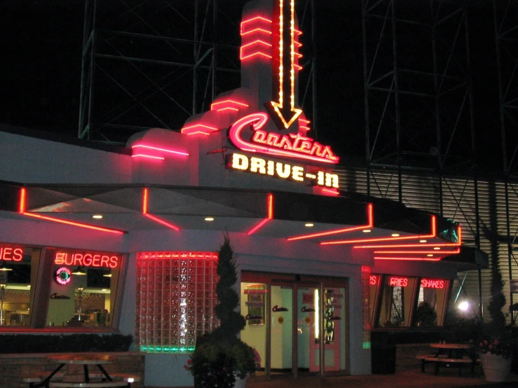 a large building with a neon sign that says, the drive - in