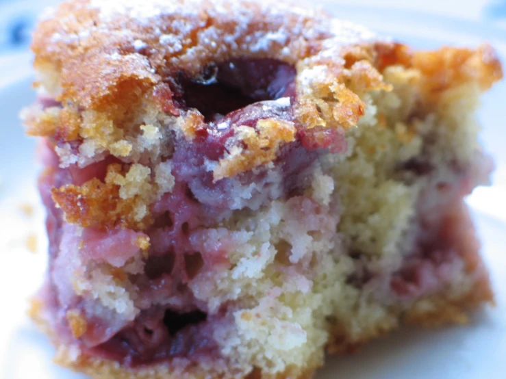 a half eaten pink and yellow cake on a plate