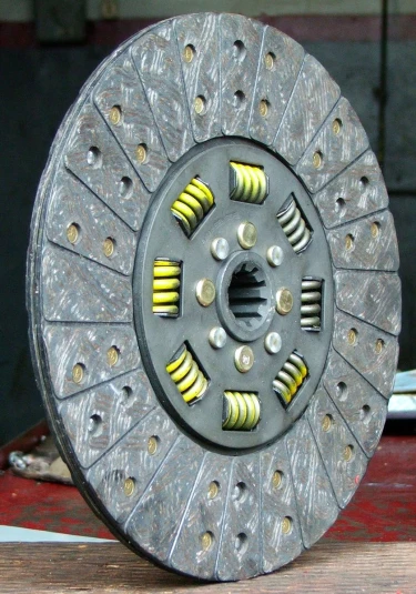 large metal disc with yellow and yellow designs