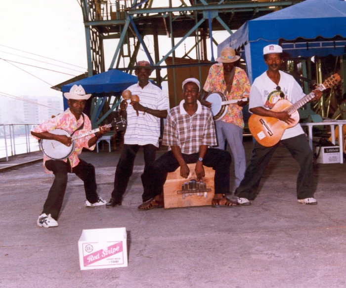 six people with guitars posing for a picture