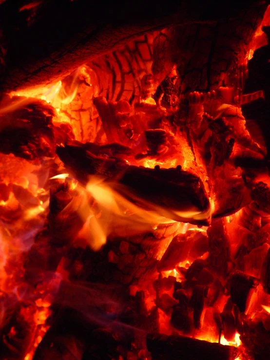 a grill with red flames and black coals