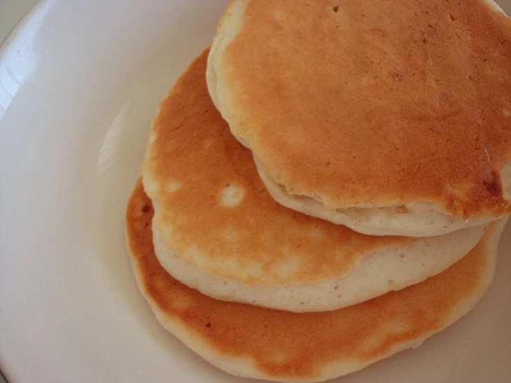 a stack of pancakes is on a plate with a blue ribbon