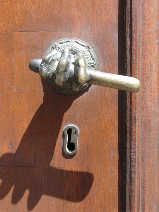 a hand that is opening a door with a handle