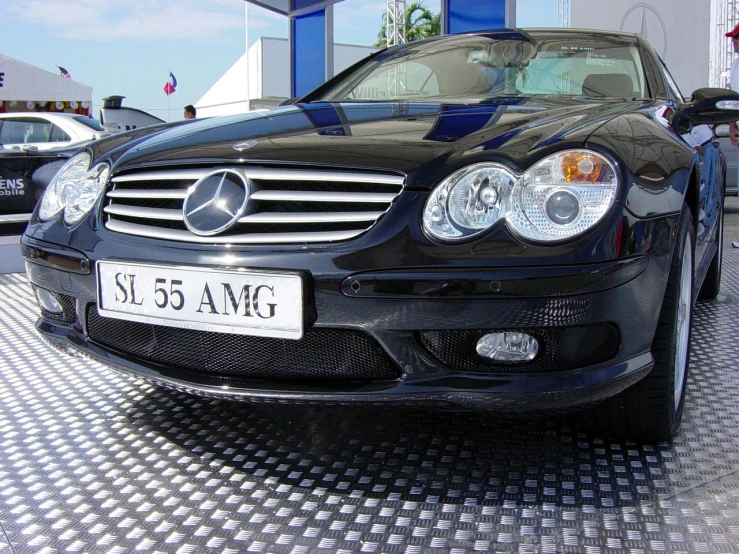 the mercedes benz cla parked next to a gas station