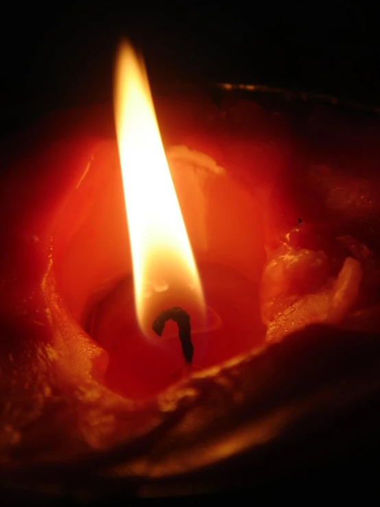 a candle that is lit and glowing in the dark