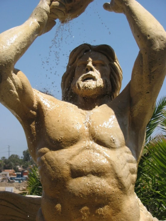 a man with  on is playing in the fountain