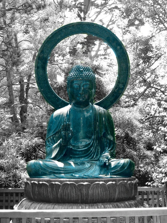 a blue buddha statue sitting on top of a wooden bench